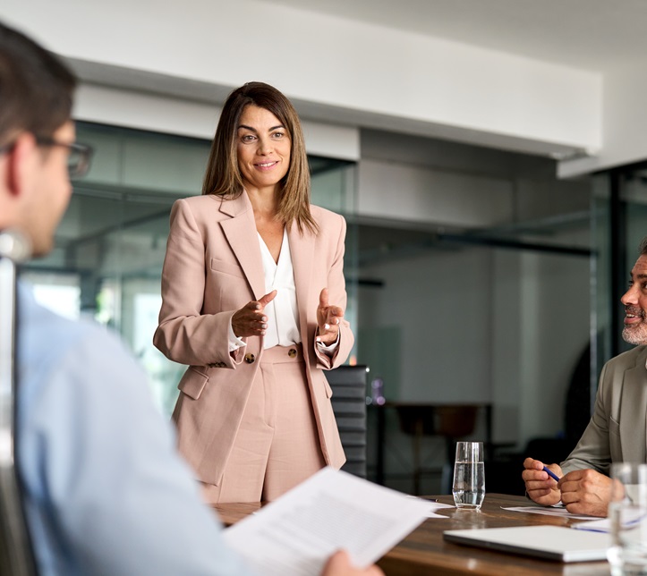 Busy mature professional board executive colleagues successful business team people collaborating having corporate teamwork discussion together at group office conference meeting boardroom table.