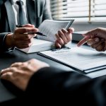 Close up of businessmen or lawyers discussing contract or business agreement at law firm office, Business people making deal document legal, justice advice service concept.