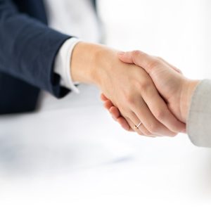 Shot of two businesswomen shaking hands in a modern office